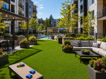Commercial multifamily property artificial grass - modern courtyard with pool and greenery